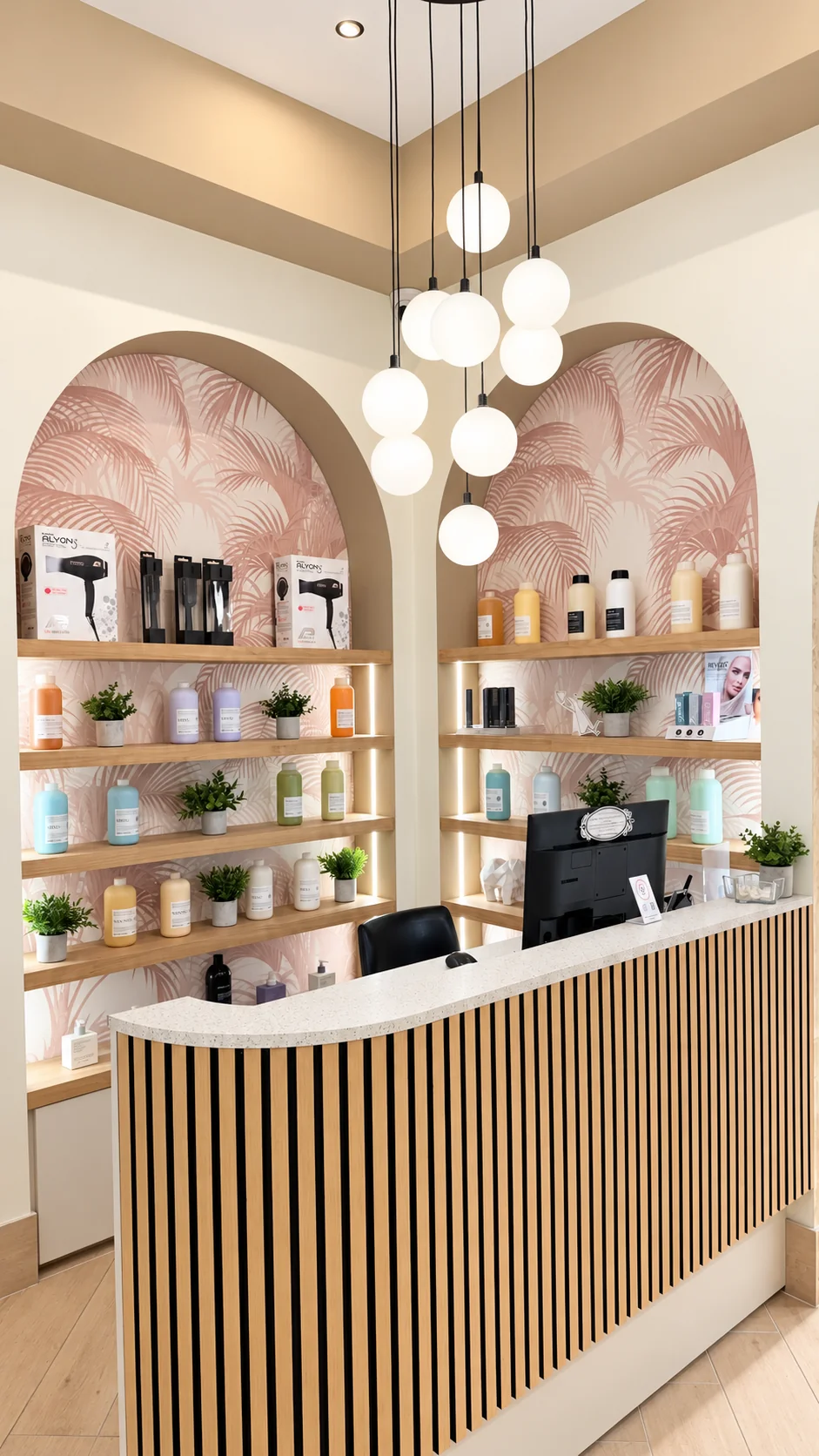 Curved reception desk beneath globe pendant lights and arched haircare displays