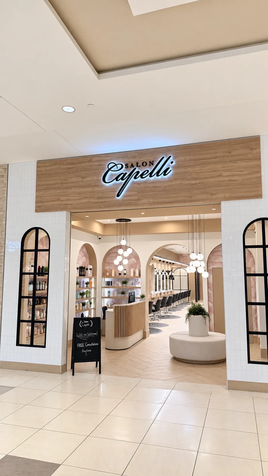 Illuminated Salon Capelli storefront opening onto the reception and styling floor at Bayshore Shopping Centre